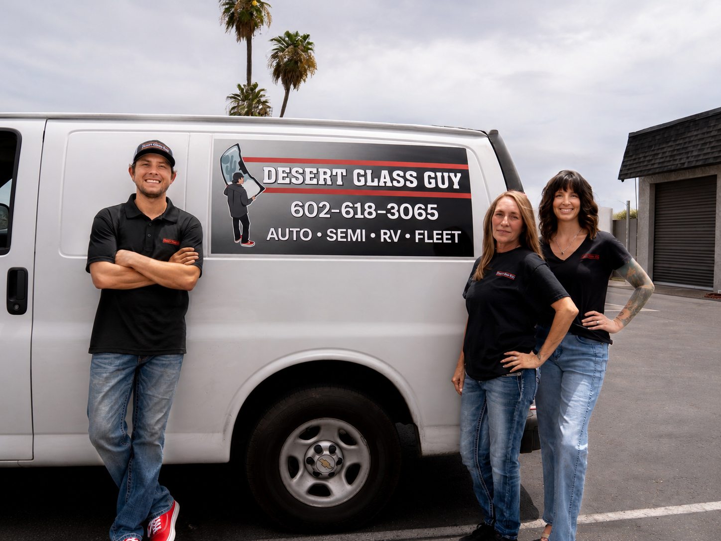 The Desert Glass Guy family team standing beside their mobile glass van